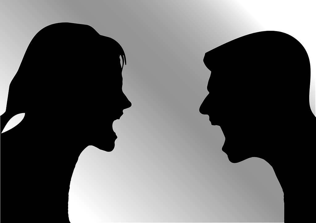 Silhouette of a man and woman arguing, with both the man and woman shouting, highlighting tension and conflict.